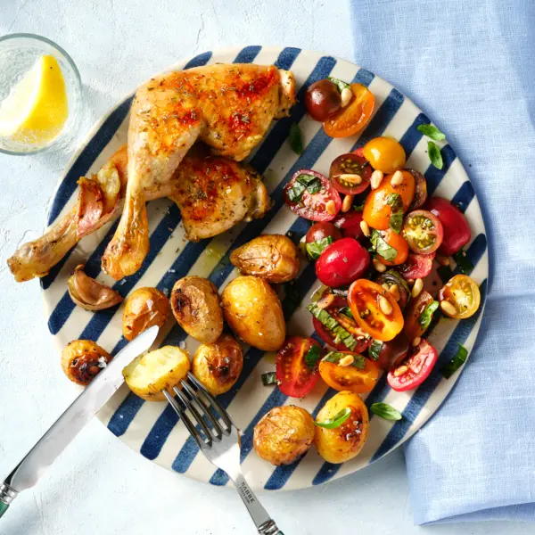 Mediterrane Hähnchenschenkel aus dem Ofen mit Tomatensalat